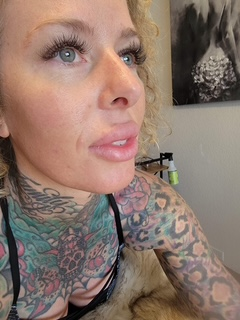 Tattooed client showing off her skin after a Skin Lab visit.