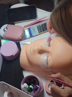 Lash extension training in progress on a mannequin at Skin Lab.