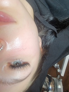 Lash extension close-up with a delicate nose piercing.