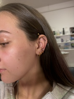 Client with fresh helix and lobe piercings, healed and healing well.