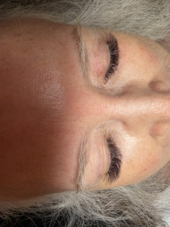 Lash lift and tint results on silver-haired client — natural lift.