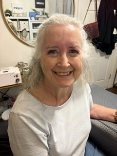 Mature client smiling after her Skin Lab lash service.
