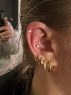 Gold cartilage stack with pave hoops — polished ear curation at Skin Lab.