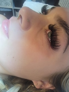Wispy lash extensions styled with a soft cat-eye.