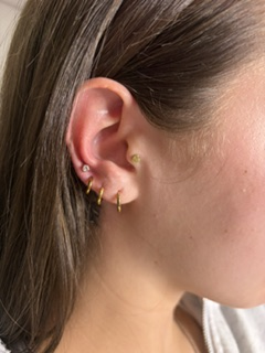Everyday gold ear stack — flatback studs and huggies.